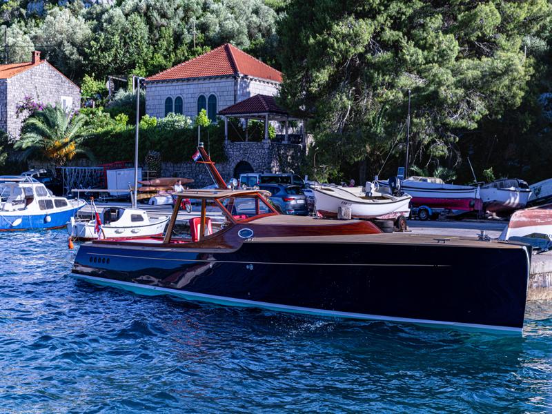 A slick boat docked at Sipan island