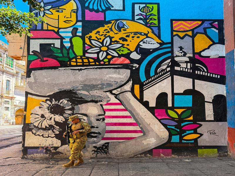 San Salvador mural with guard