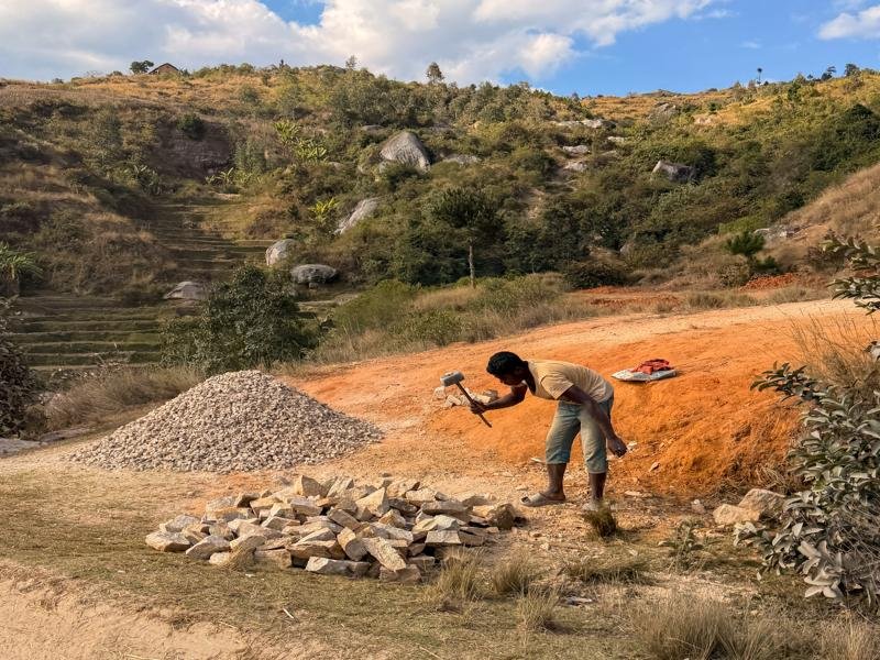 Chopping up the large rocks by hand, also common