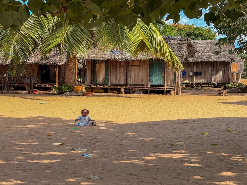 A baby amusing itself in the village