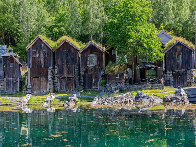 Old buildings along the shore in Geiranger